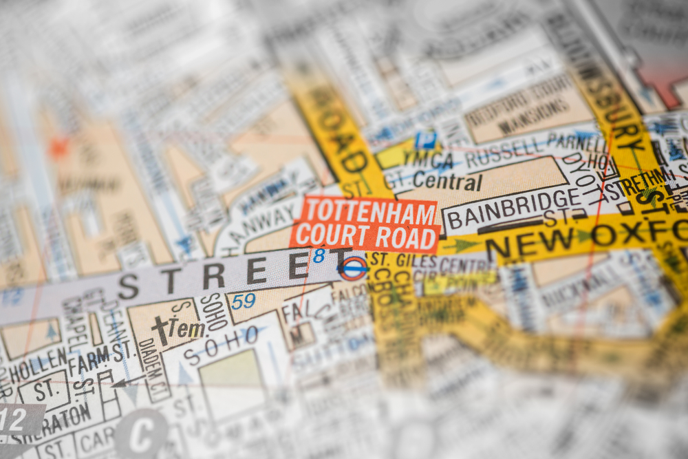 A close-up of a map highlighting Tottenham Court Road in London, with surrounding streets and landmarks such as Bainbridge Street and New Oxford Street visible. The area is marked with bright colors and clear labels.