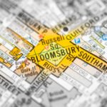 A close-up of a city map highlighting the Bloomsbury area in central London with a yellow star, showing surrounding streets and locations such as Russell Square and Southampton Row.